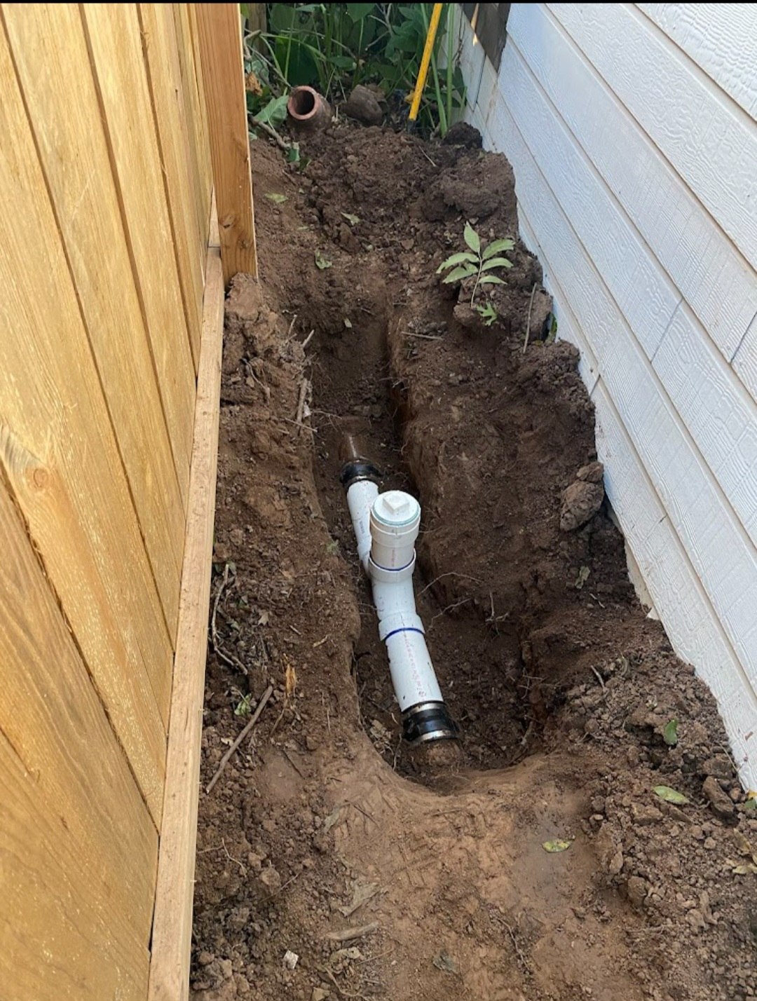 Underground sewer line repair with new pipe and cleanout